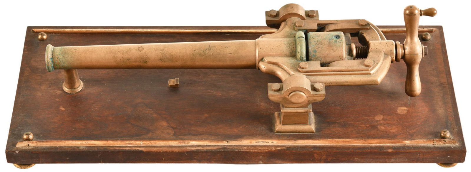 Black Powder Signal Cannon: Brass and wood construction, cannon mounted on wooden platform, cannon and base show signs of wear, discoloration, oxidation, tarnish, minor pitting, paint loss, with a few nicks in the wooden base, p