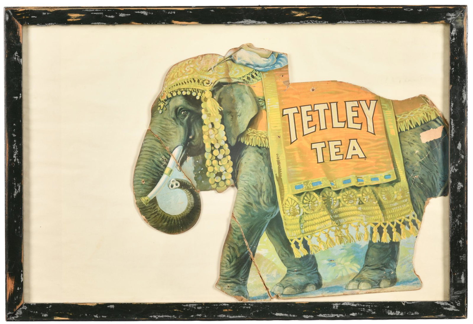 Tetley Tea Framed Elephant Advertisement: Die cut cardboard, has average color, shows wear, creases/folds, discoloration, added holes, tears, paint loss, and cardboard damage, frame shows wear and paint loss, displays well with the elephant g