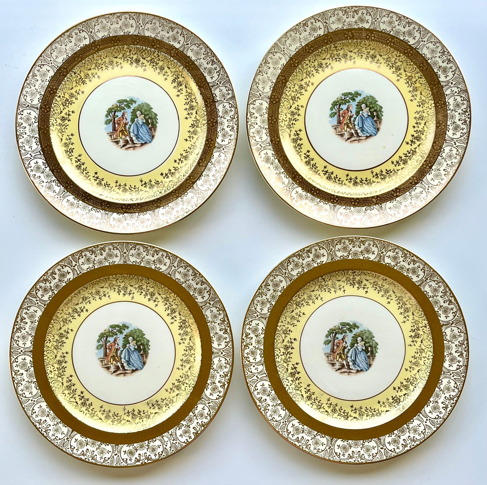 Victorian Style Bromley Plates Set of 4 –22K Gold Trim,Courting Couple Scene 10in: Set of 4 vintage Bromley decorative plates featuring a romantic courting couple scene in the center. Elegant ornate border with rich 22K gold trim. Marked on back: “Brumley – Decorated – 22