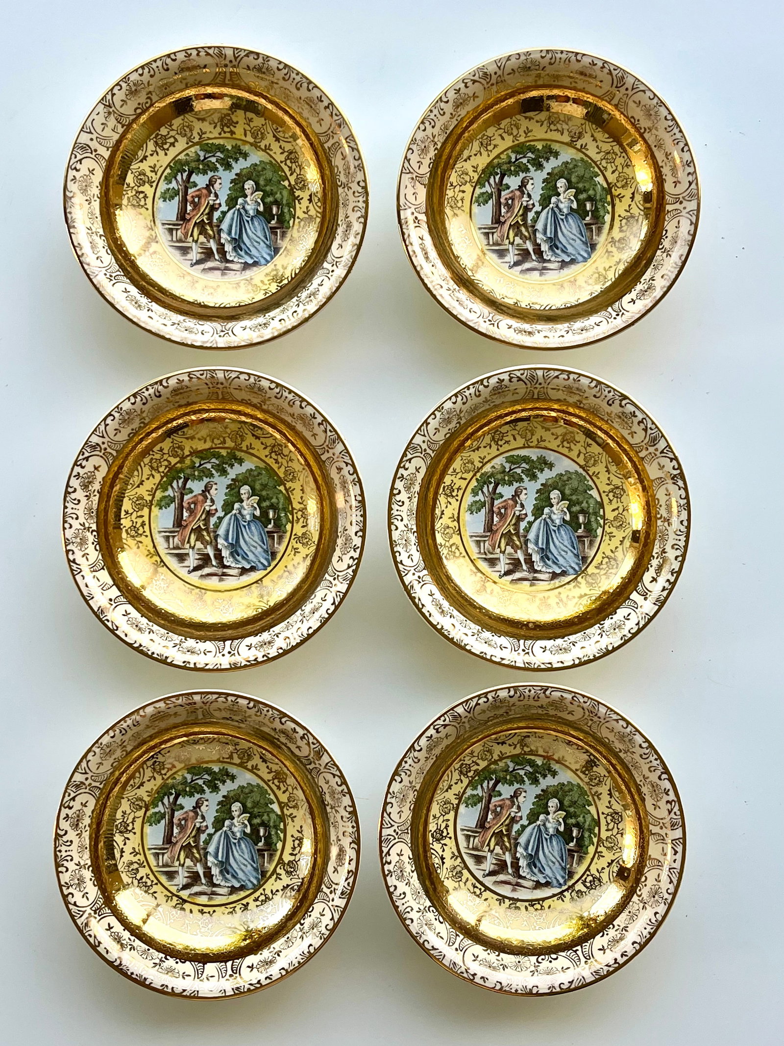 Victorian Style Porcelain Plates Set of 6 – 22K Gold Trim 5 inches Bromley: Set of 6 vintage Bromley decorative plates little bowls featuring a romantic courting couple scene in the center. Elegant ornate border with rich 22K gold trim. Marked on back: Bromley – Decorated �