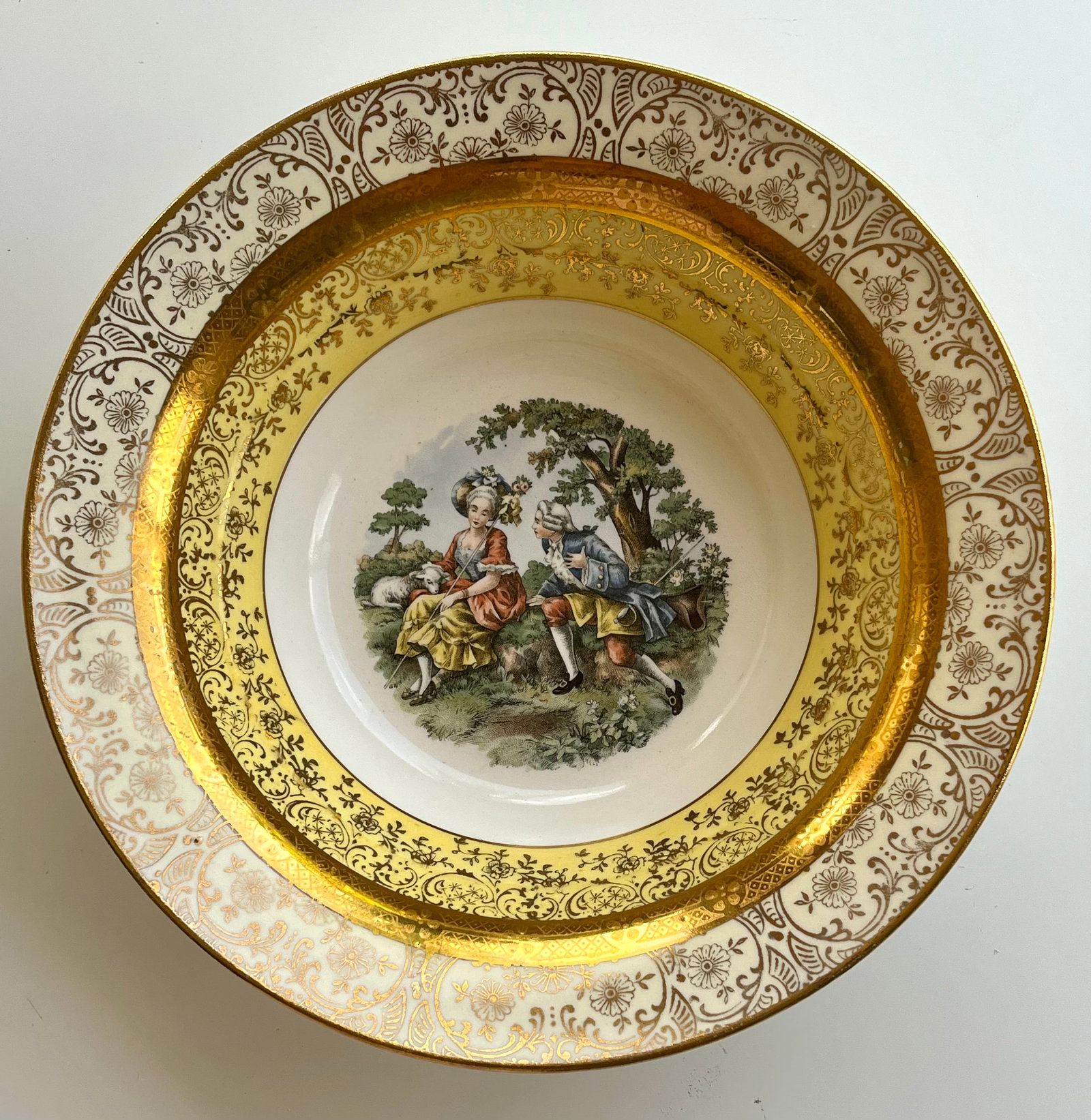 Victorian Style Porcelain 22k gold Bromley Soup Bowl – Rococo Courting Scene, Gold Gilded Trim,: Charming vintage porcelain soup bowl by Bromley, Germany, circa 1950s–1970s. Features a romantic Rococo-style courting couple scene, intricate gold floral gilt trim, and a rich cream and yellow bord