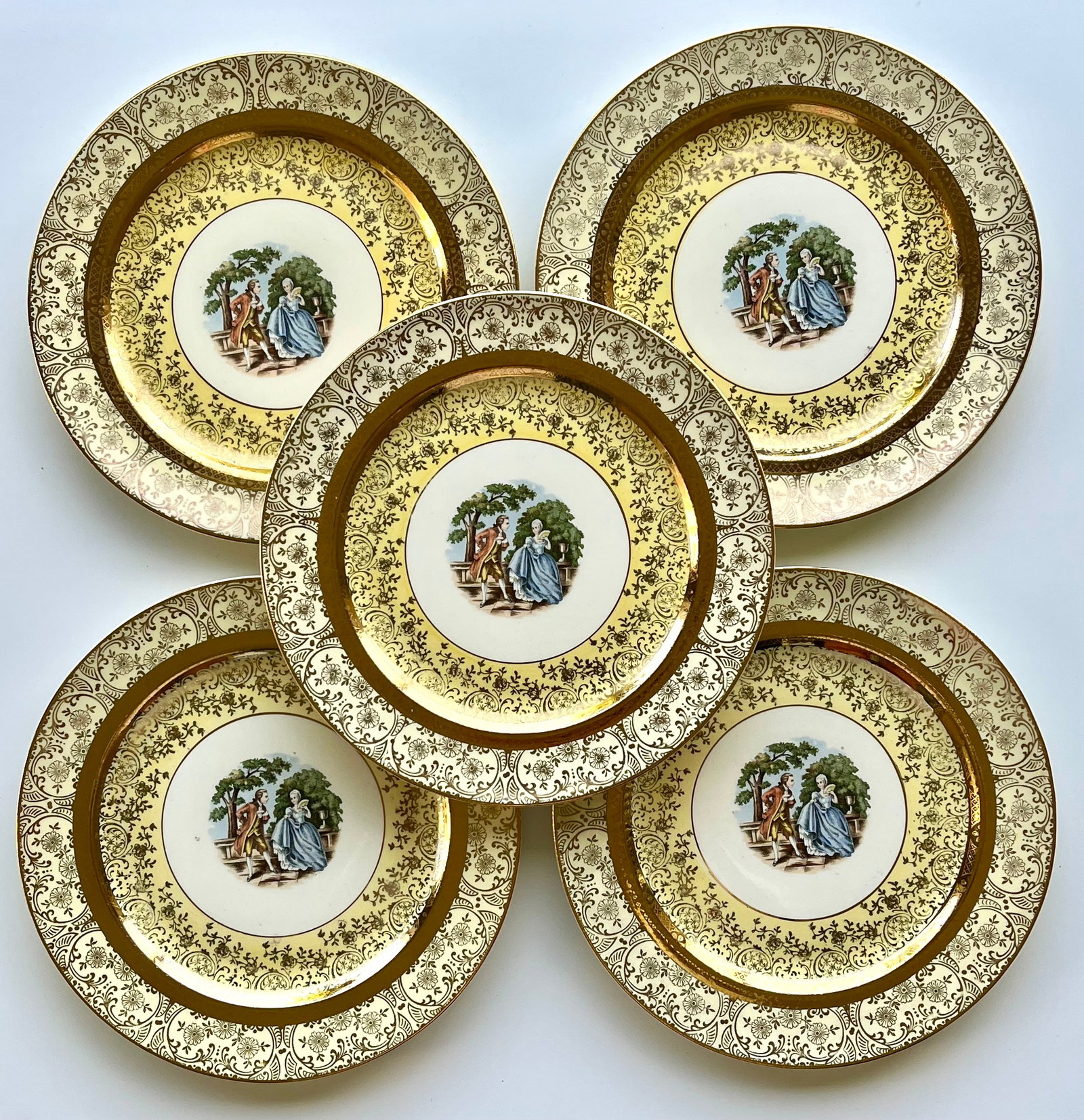 Victorian Style Porcelain Bromley Plates Set of 5 –22K Gold Trim 9 inches: Set of 5 vintage Bromley decorative plates featuring a romantic courting couple scene in the center. Elegant ornate border with rich 22K gold trim. Marked on back: Bromley – Decorated – 22 Karat