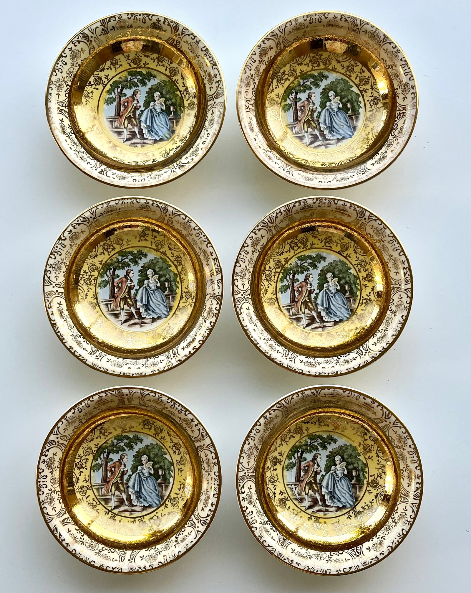 Victorian Style Porcelain Plates Set of 6 – 22K Gold Trim 5 inches Bromley: Set of 6 vintage Bromley decorative plates little bowls featuring a romantic courting couple scene in the center. Elegant ornate border with rich 22K gold trim. Marked on back: Bromley – Decorated �