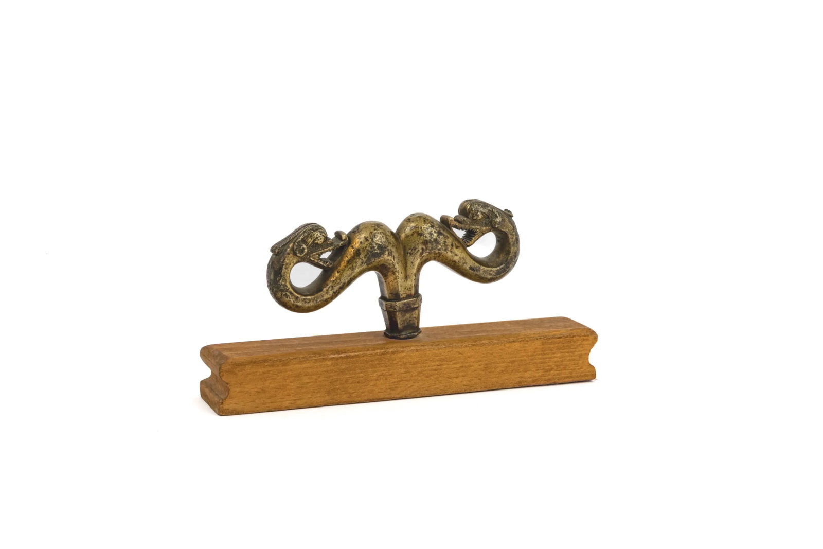 Bronze pastoral staff tip: Bronze pastoral staff tip featuring two dragons facing each other, characteristic of Armenian vartabed gazavans.Armenia, 18th century.On a rectangular wooden base.