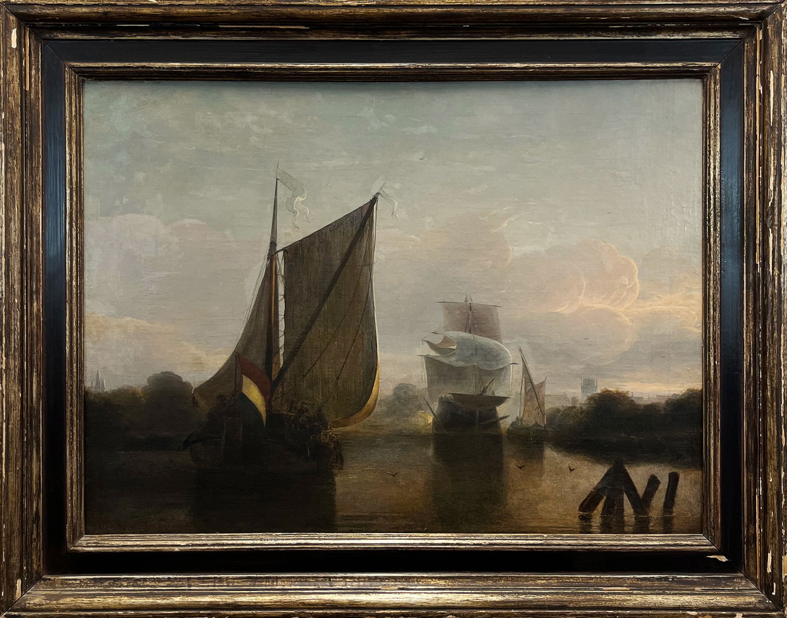 In the Style of Salomon van Ruysdael, 19th Century Oil Painting of a Nautical Scene: One oil on canvas painting depicting three ships within a coastal landscape. The piece is painted in the style of Dutch Golden Age painter Salomon van Ruysdael. The large ship in the foreground displa