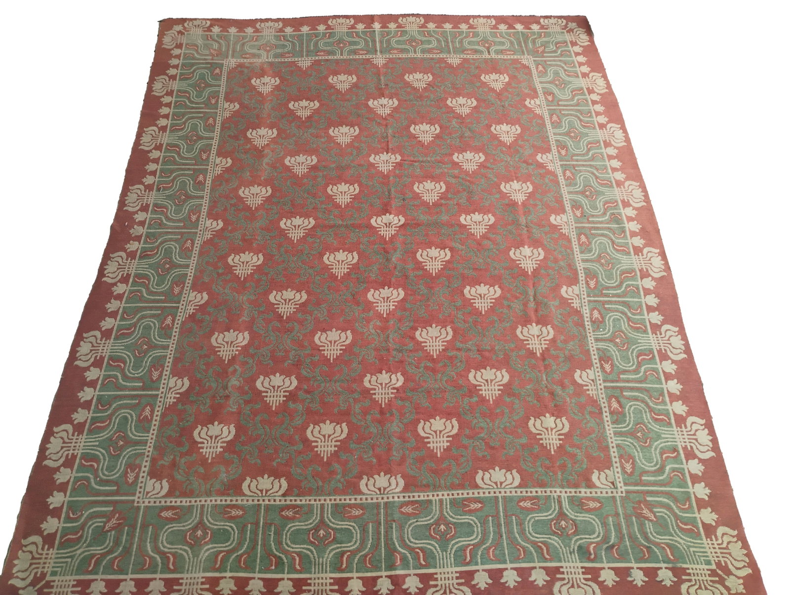 Vintage Hand Knotted Irish Rug: One vintage hand-knotted Irish wool rug featuring a symmetrical floral motif rendered in soft hues of rose, sage green, and cream. The central field is adorned with a repeating pattern of stylized tul