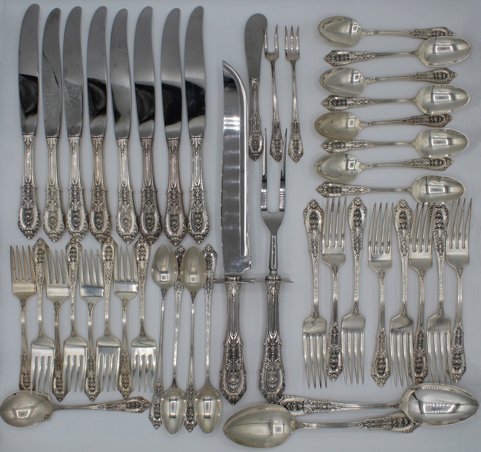 44-count Rose Point Wallace c. 1934 Sterling Silver Flatware Set: A fine and well-preserved 44-piece sterling silver flatware set in the Rose Point pattern by Wallace, first introduced in 1934. This elegant collection showcases the pattern’s signature pierced rose