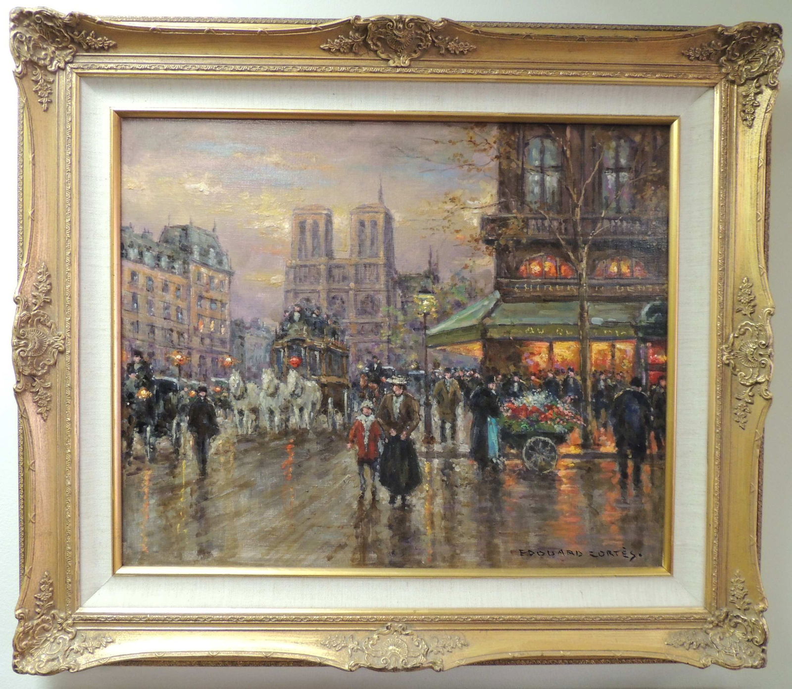 Edouard Cortes, "L'Avenue de Champs Élysées", Signed Oil Painting: One 20th century oil on canvas depicting a Paris street scene at dusk. People and carriages fill the streets of Paris lined with cafes and buildings. Notable landmarks such as Notre-Dame and stand out