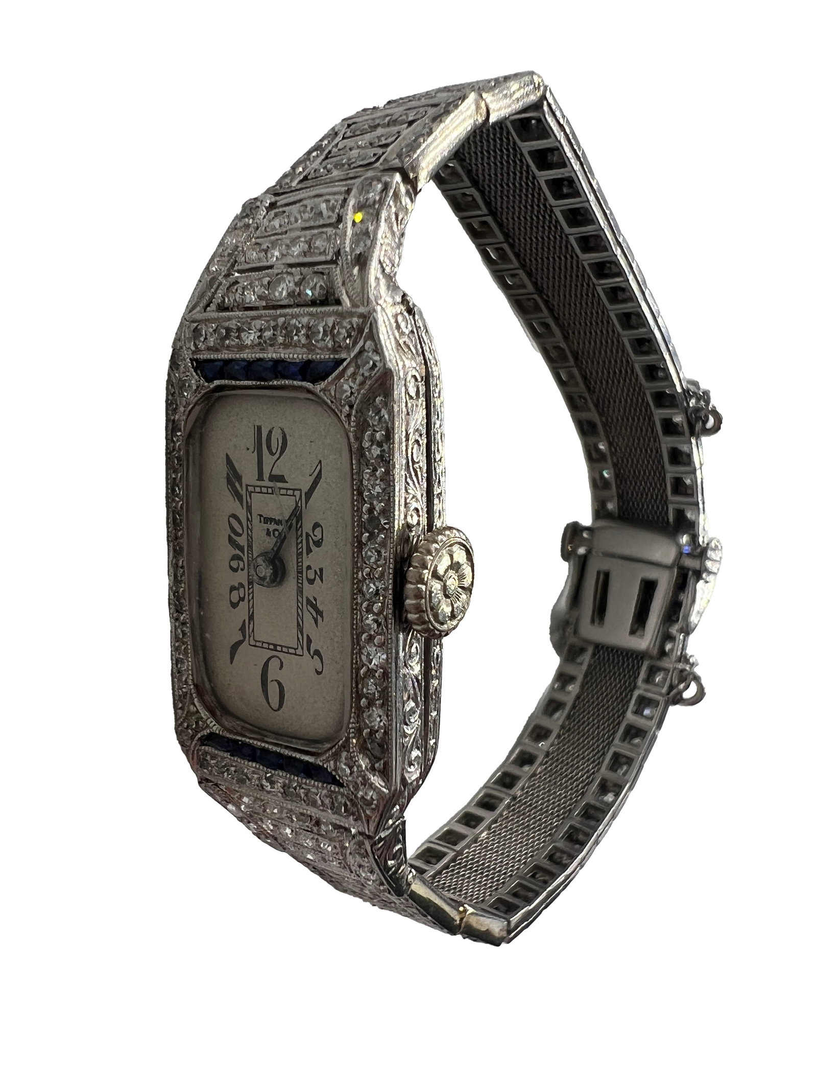 Art Deco Tiffany & Co. Platinum, Diamond, and Sapphire Watch: One Art Deco Tiffany & Co. platinum, diamond, and sapphire watch with mesh style straps set with numerous small diamonds and sapphires. Circa 1925. Tiffany & Co is present on the watch face. 20.7 dwt 