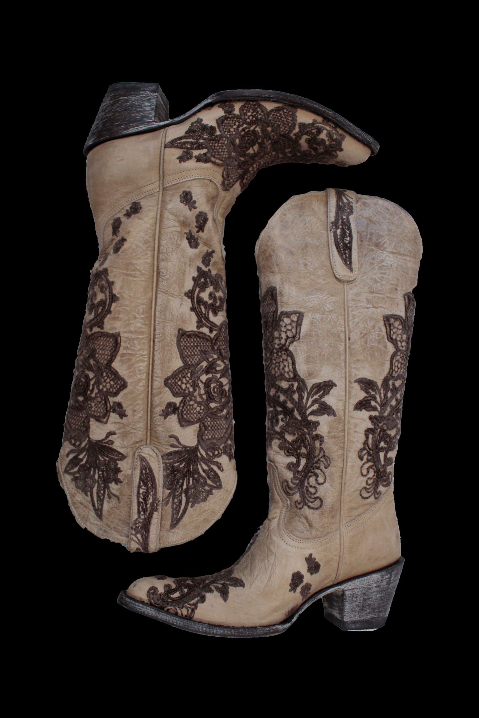 Cowboy Boots: One pair of vintage women's cowboy boots with brown floral embroidery. These sturdy shoes are a unique take on a Western classic. US size 7B. Medium width. 16 x 10 x 4 in.This lot comes from a disting