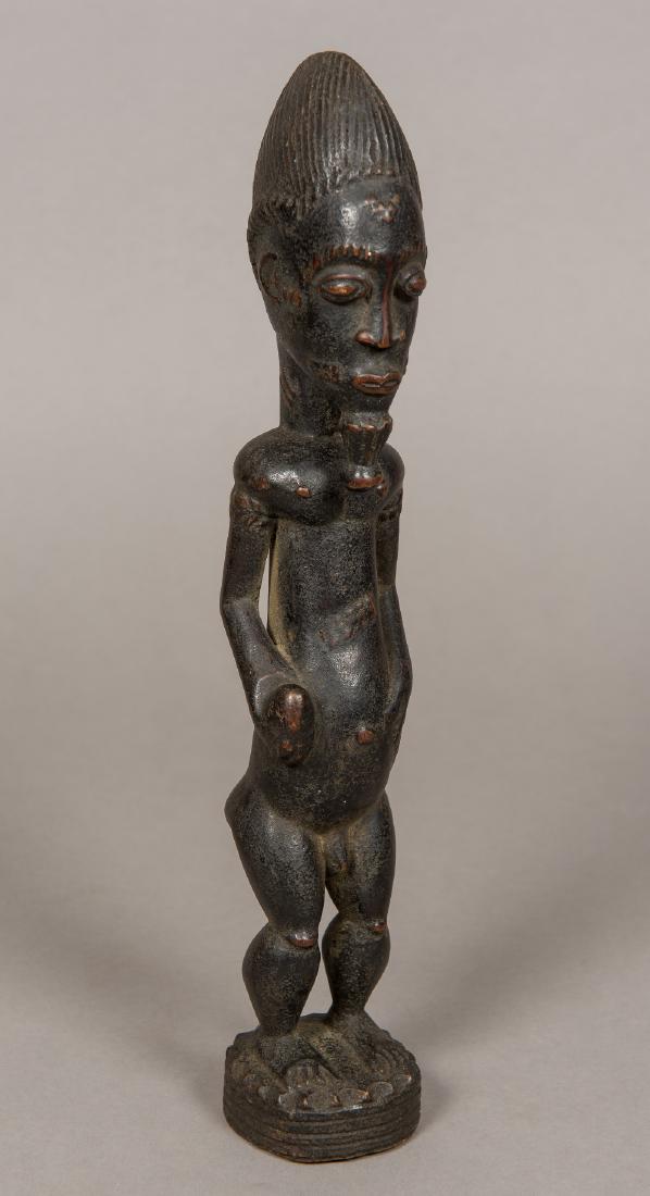 An African tribal carved wooden figure Formed as a (1 of 7)