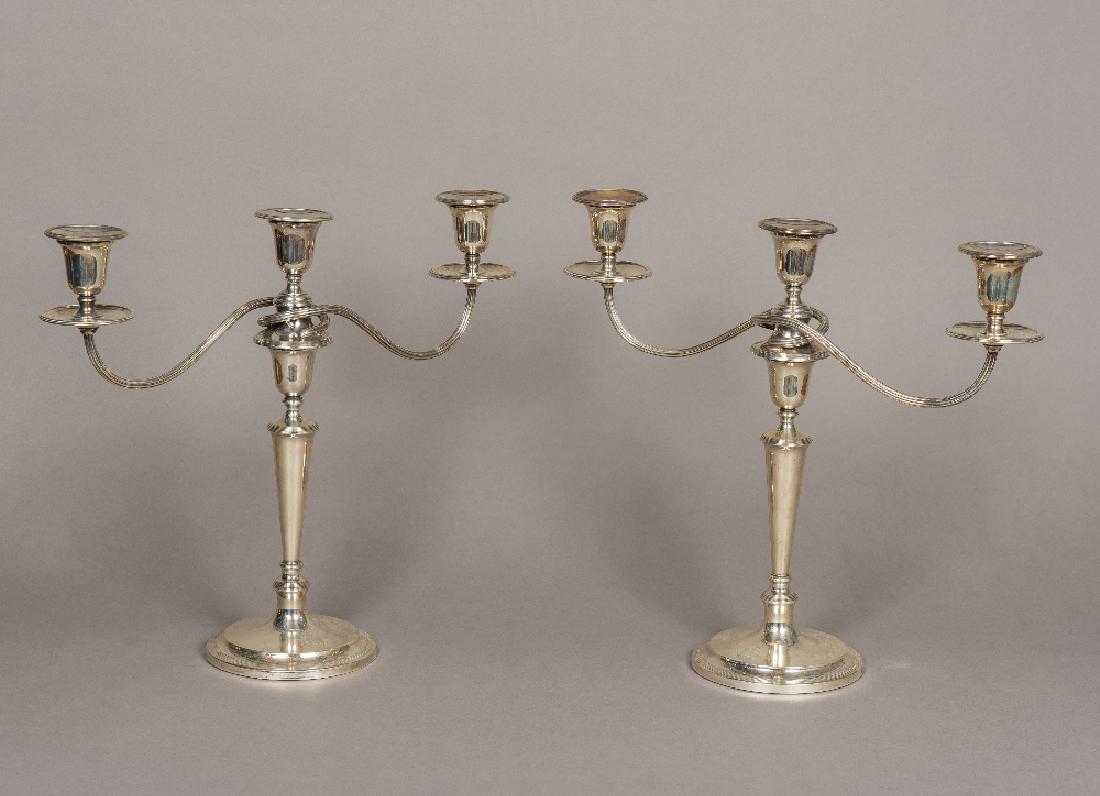 A pair of mid 20th century silver candelabra,: A pair of mid 20th century silver candelabra, hallmarked London 1969, maker's mark of CGV Limited Each with twin scrolling branches above the tapering stem, standing on stepped spreading domed foot, e