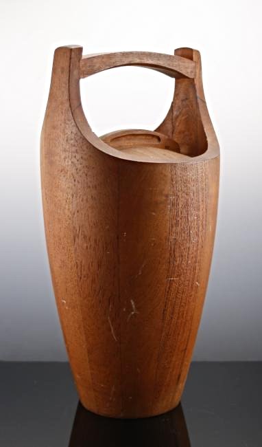 Mid Century Dansk Teak Ice Bucket: Sleek and sculptural, this mid-century modern ice bucket is crafted of teak and boasts a coordinating lid. Stamped for ensured authenticity. Dimensions: 16"H x 7"DIA. Priority Shipping provided in-hou