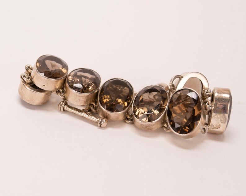 Sterling & Smoky Topaz Toggle Bracelet: Vintage 925 Sterling Silver & Smoky Topaz Gemstone Toggle Bracelet. This sleek, circa 1980's-90's sterling silver bracelet is in excellent condition. It features eight, sparkling, smoky topaz stones n
