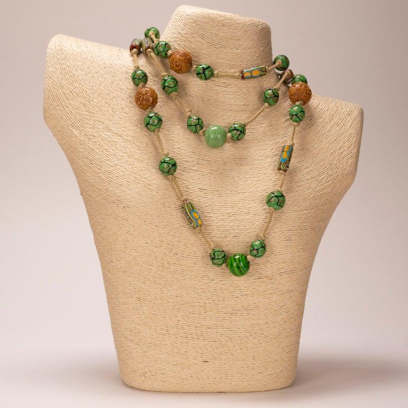 Art Deco Glass & Carved Bead Necklace: Vintage Czech Art Deco Glass & Carved Resin Bead Necklace 48" Long. This unique, long beaded rope necklace is in excellent condition. It is comprised of what appears to be ceramic, carved resin and ar