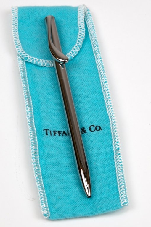 TIFFANY & CO Elsa Peretti Silver Ballpoint Pen: Authentic TIFFANY & CO Elsa Peretti Silver Retractable Ballpoint Pen. Approximately 5" long. Includes box and pouch. Silver, Ruthenium over brass. Some signs of use and wear, including some surface sc