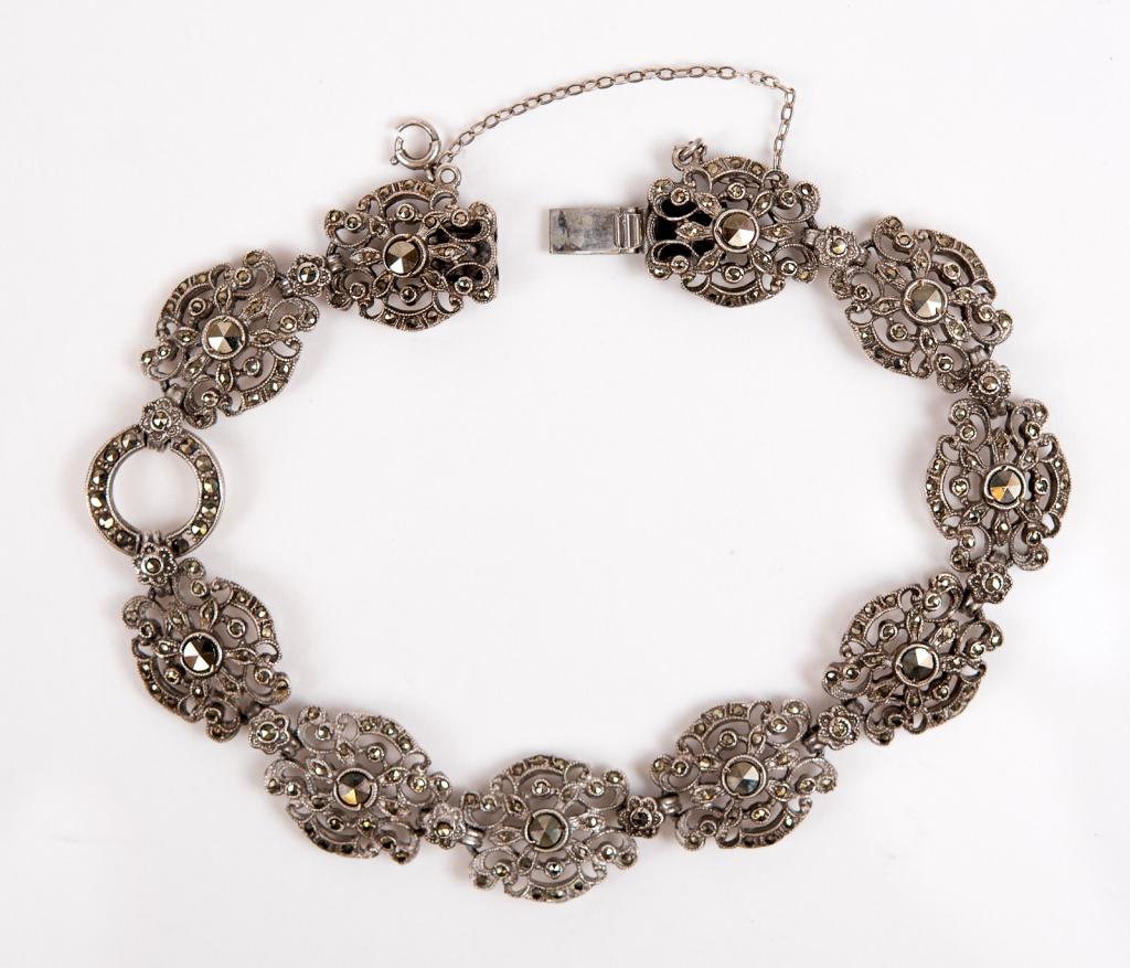 Antique Sterling & Marcasite Floral Panel Bracelet: Item/Description: Antique Sterling & Marcasite Floral Station Bracelet. Deco era bracelet with exquisite workmanship and detail. Hand-set large and small marcasite studded floral panels; alternate wit