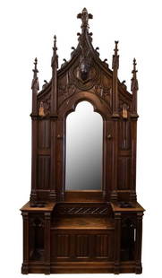 Gothic Revival Hall Tree with Mirror, Bench Seat: Item/Description: Grand, hand-carved wood coat rack / hall tree, umbrella stand. Fit for a castle or hunting lodge. Features mirror with carved goat's head and applied hooves. Bench seat opens to