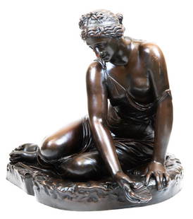 After Ferdinand Barbedienne, Venus Holding Shell: Item/Description: A large, antique patinated bronze sculpture portraying Venus, loosely draped and seated on a beach. She is surrounded by shells and holds a scallop in her hand. Demure, intimate