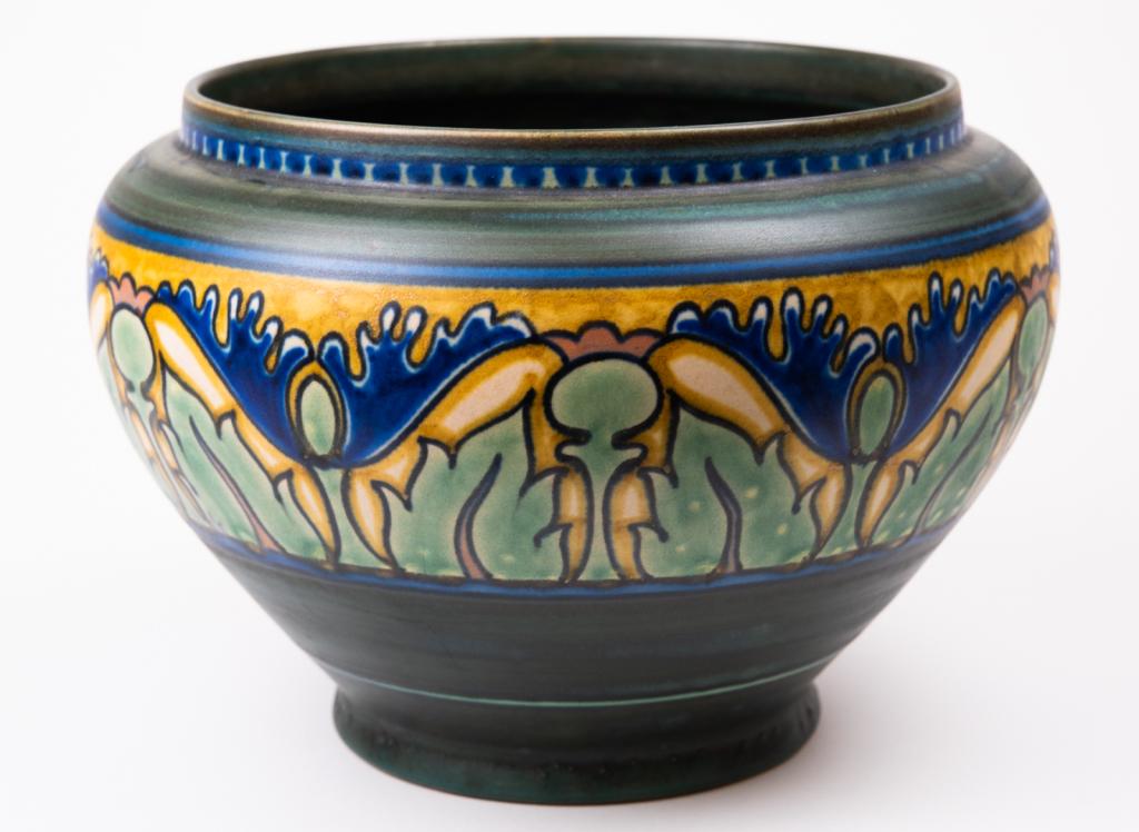 Signed Gouda Holland Art Pottery Bowl: Item/Description: Signed, hand-painted bowl in greens, blues and yellows. Blue poppies. Signed and numbered on bottom. Damascus III Gouda, Holland. Material: Pottery. Dimensions: Diameter: 9"; Height: