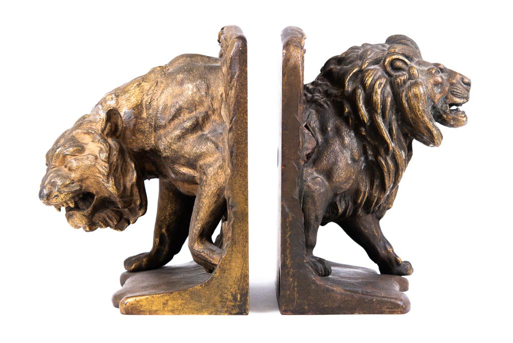 Bradley and Hubbard B&H Lion Bookends: Item/Description: Majestic Lion & Lioness bookends in gilt and bronze tones. Life-like, roaring poses. B&H makers mark stamp on back. Material: Cast Iron. Dimensions: Length: 5 3/4"; Width: 5"; Height