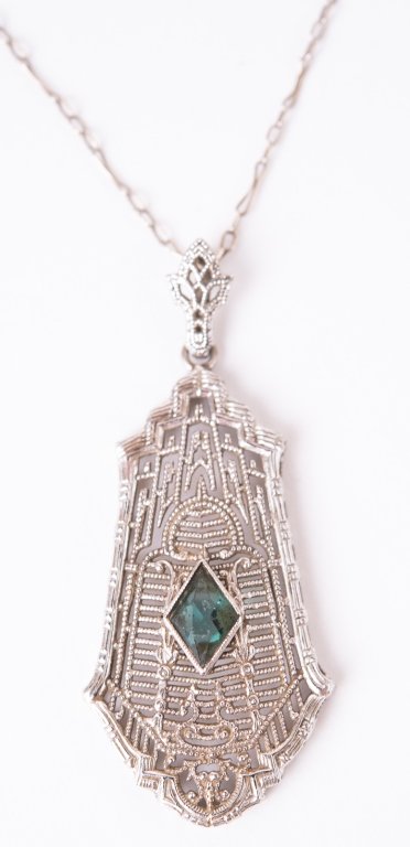 Art Deco 10K Filigree Tourmaline Pendant Necklace: Item/Description: Delicate Art Deco Antique 10K White Gold Filigree Tourmaline Pendant Necklace. Ornate, open pierce- work drop features diamond shape green Tourmaline. Matching bail. Period paper cli