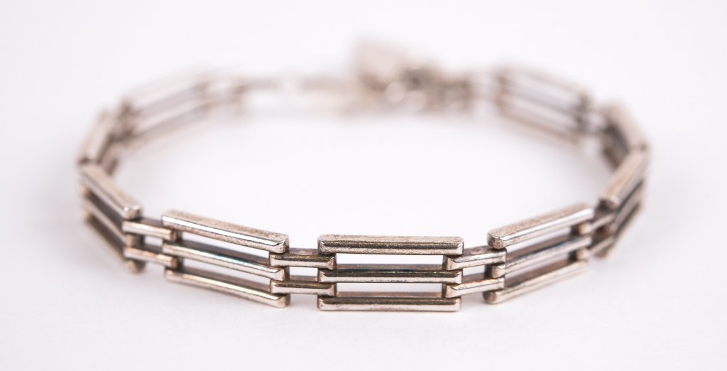 Vintage English Sterling Heart Padlock Bracelet: Item/Description: Known as a "gate bracelet" this vintage Sterling Silver bracelet features links that resemble a fence/gate and a heart padlock charm that serves as a clasp. Back of heart hallmarked: