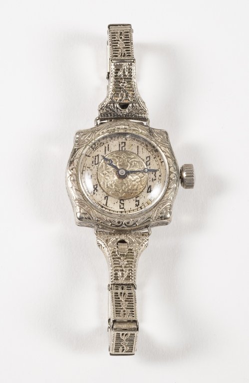 Antique Art Deco 12K Gold Filled Women's Watch: Item/Description: Ornate filigree manual winding watch features bubble crystal; silver colored engine turned/ embossed dial, anodized blue hands, Deco numerals. Filigree link stretch band; fold-over h