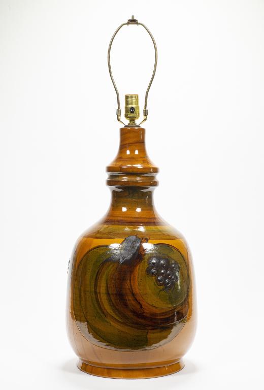 Mid Century Glazed Table Lamp: Item/Description: Table lamp with glazed finish. Raised grape motif. Material: Ceramic. Dimensions: Diameter: 11"; Height without harp: 22". Condition: Surface wear. Age: 20th Century. Provenance: Pr