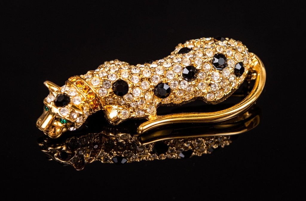 Vintage Giorgio Armani Jeweled Leopard Brooch: Item/Description: Signed jeweled figural pin of crouching leopard. Fashioned in shiny gold tone metal, encrusted with clear and black crystal rhinestones. Green crystal eyes, wearing a citrine crystal