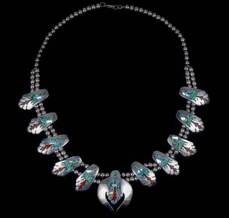 Cecil Ashley Sterling Silver Native American Bib: Item/Description: Magnificent ,Navajo artist signed bib necklace boasts ten medallions of a soaring Phoenix bird inlaid with chips of Turquoise and Coral flanking a center larger medallion. Strung on