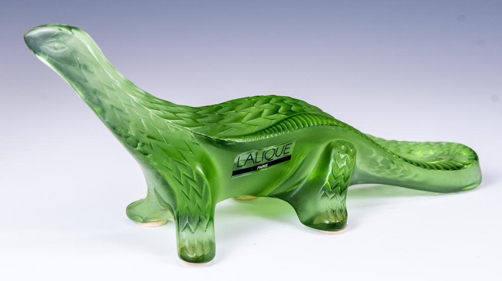 Lalique Green Glass Dinosaur / Lizard: Item/Description: Signed dinosaur in green glass. Features scale detail. Signed on bottom. (Art Glass) Material: Colored glass. Dimensions: Length: 7"; Height: 2 3/4". Condition: Minor surface wear. N