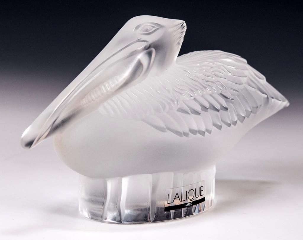 Lalique Crystal Pelican Sculpture: Item/Description: Frosted and clear glass figurine of a pelican by Lalique France. Signed on bottom. Includes original Lalique box and packaging as shown. (Art Glass, Sea Bird) Material: Glass. Dimens