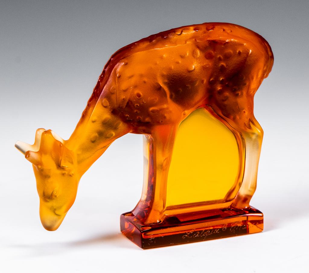 Lalique Amber Daims Deer / Fawn Sculpture: Item/Description: Amber glass deer figurine by Lalique France. Signed on base. Includes original Lalique box and packaging as shown. (Art Glass, Animal, Collectible) Material: Glass. Dimensions: Heigh