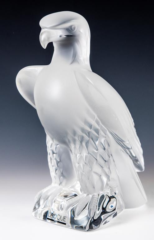 Lalique Aigle Liberty Standing Eagle Figure: Item/Description: Large Standing Eagle / Liberty sculpture by Lalique France. Signed on bottom. Includes original Lalique box and packaging as shown. Material: Frosted glass. Dimensions: Height: 9"; W