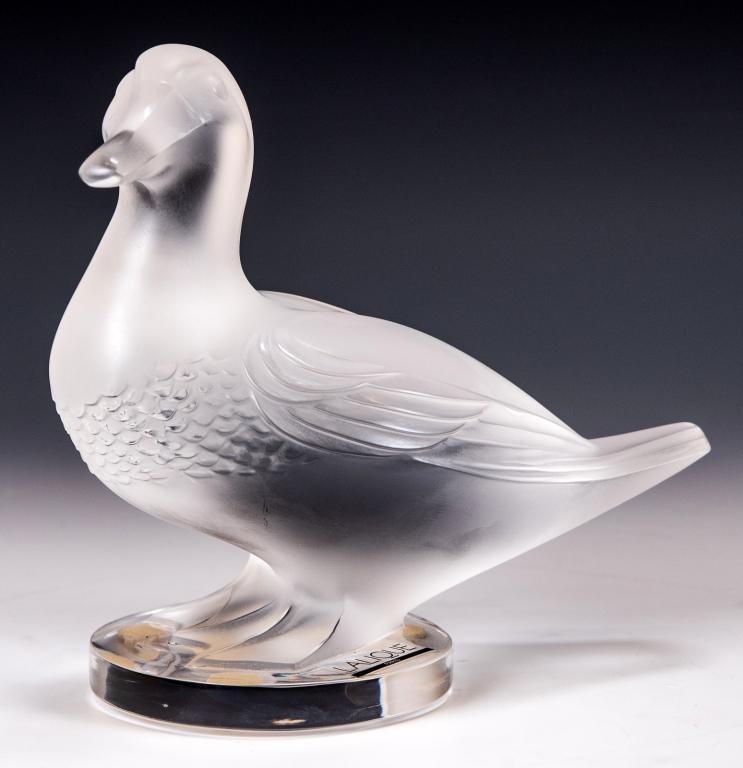 Lalique Frosted Glass Duck Sculpture 'Gedean': Item/Description: Crystal figure of a standing duck by Lalique France. Signed on base side. Includes original Lalique box and packaging as shown. (Art Glass, Bird Figurine) Material: Glass. Dimensions