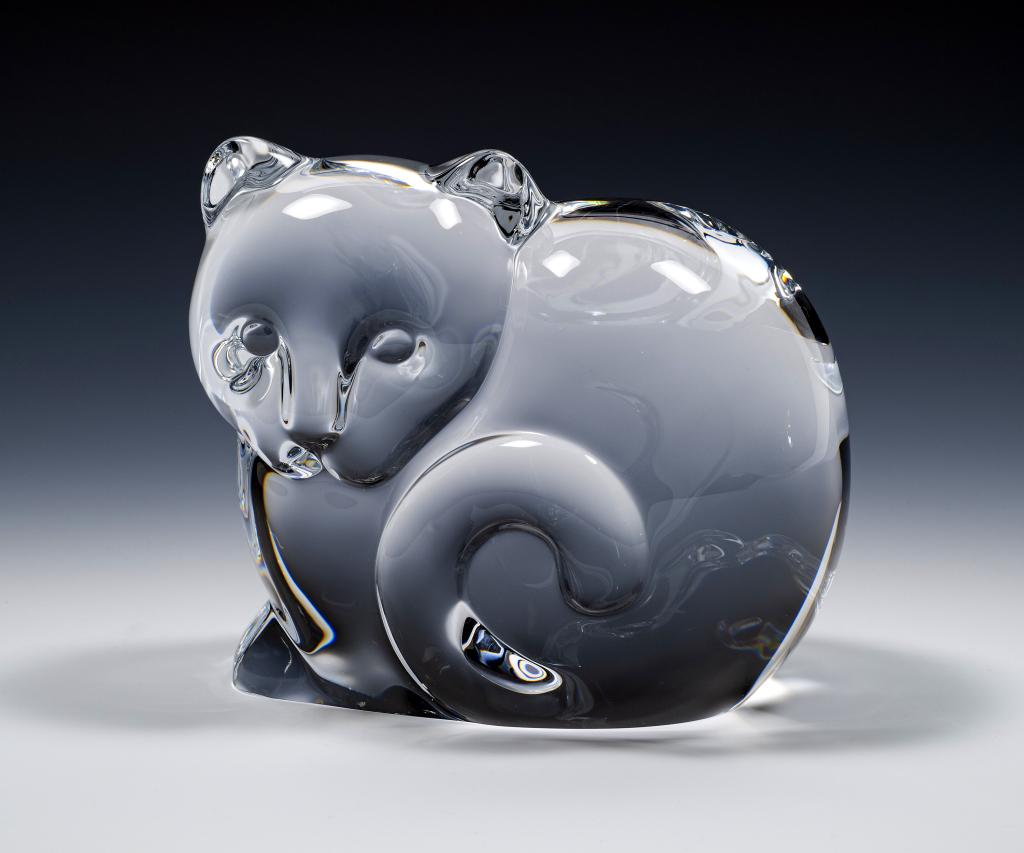 Tiffany & Co. Art Glass Cat Paperweight: Item/Description: Clear crystal cat sculpture by Tiffany & Co. Signed on bottom. Material: Glass. Dimensions: Height: 3 1/2"; Width: 4". Condition: Minor surface wear. No noticeable chips or cracks. A