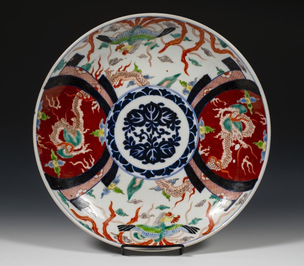 Hand Painted Large Imari Plate: Item/Description: Decorative Imari dish features blue and white center medallion surrounded by dragon and Rooster. (Japanese, Charger) Material: Porcelain. Dimensions: Diameter: 12". Condition: Age an
