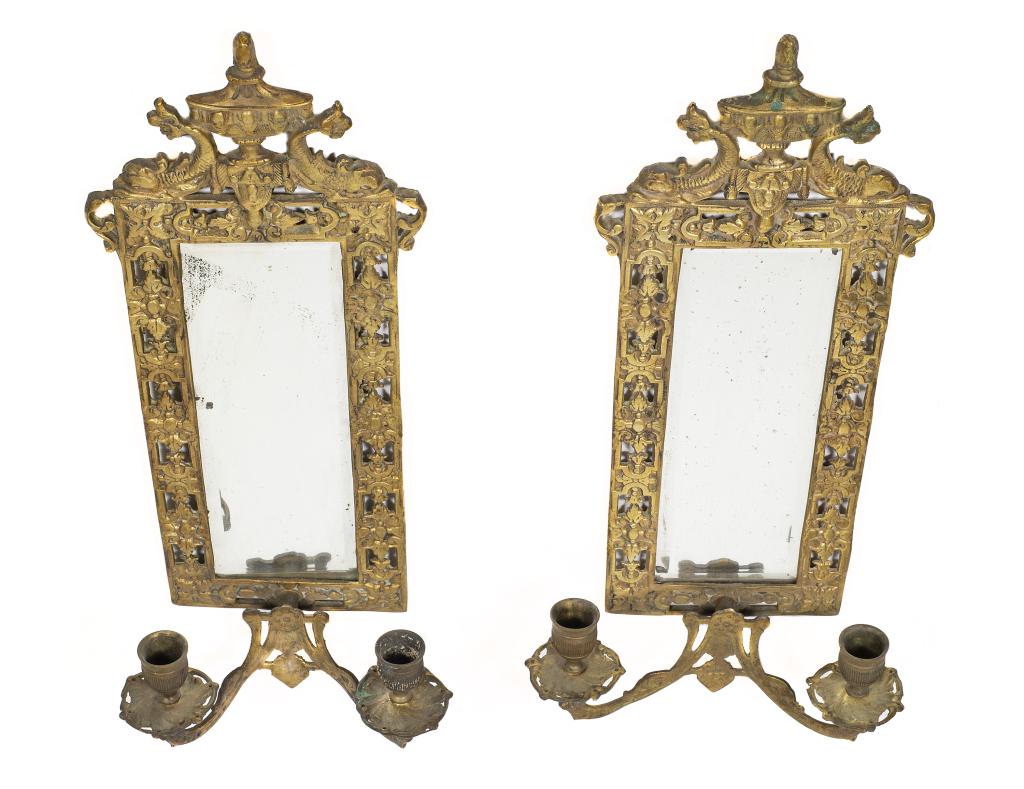 Pair of Antique Brass Dauphin Sconces: Item/Description: Antique Victorian Fish Motif Brass Candle Sconce Mirror Pair. Antique Brass Mirrored Wall Sconces: with pair of candle holders per side. Dolphin and urn top finial with filigree fram