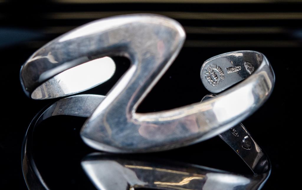 Taxco Signed Modernist Sterling Cuff: Item/Description: Modernist, sleek zig- zag Sterling Silver Mexican cuff bracelet. Hallmarked: Sterling Taxco MSM/R ( last letter stamp illegible) Eagle 3 assay. Material: Sterling Silver. Dimensions: