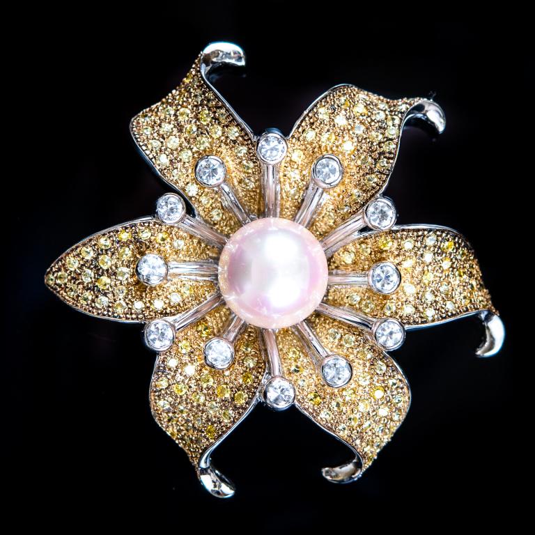 Pearl & Rhinestone Flower Pendant Pin: Item/Description: Exquisite costume brooch pendant fashioned as an open flower. Surface encrusted with quality yellow crystals in open back gold-tone setting. Center, lustrous raised pearl; stamens wi