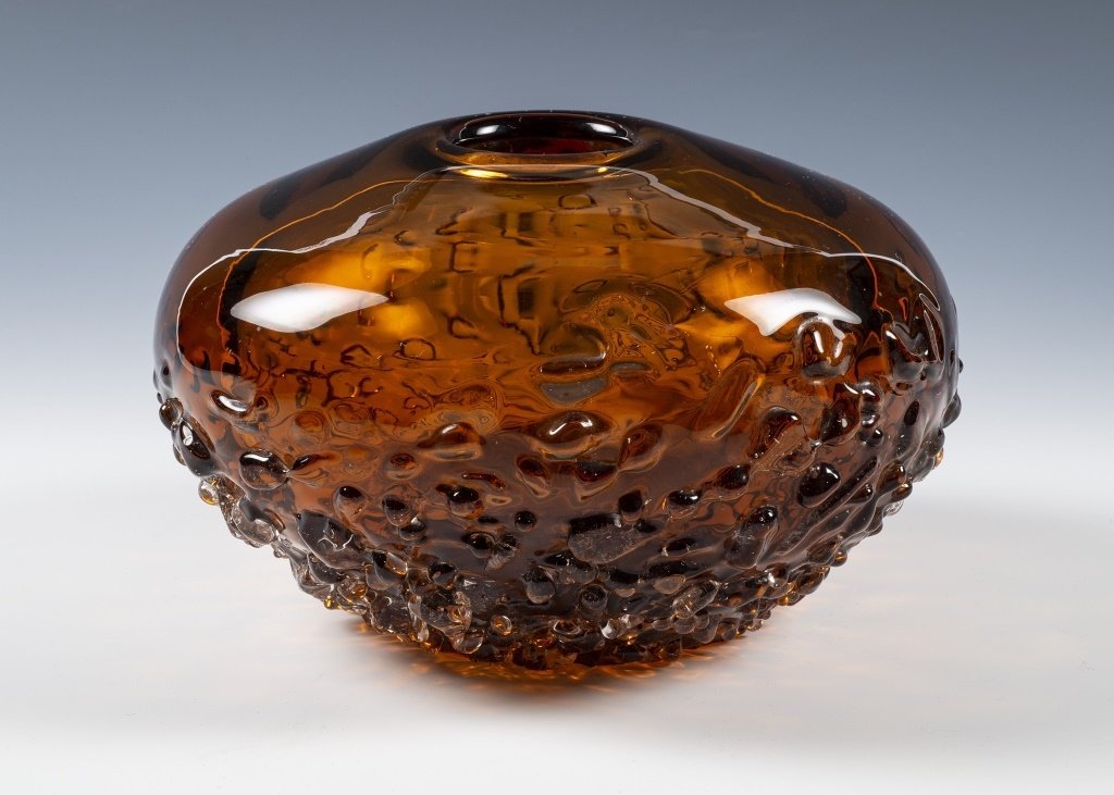 Mid Century Modern Textured Amber Glass Vase: Item/Description: Amber glass vase. No noticeable signature or makers mark. Material: Glass. Dimensions: Diameter: 5 3/4"; Height: 4". Condition: Minor surface wear. No noticeable chips or cracks. Age