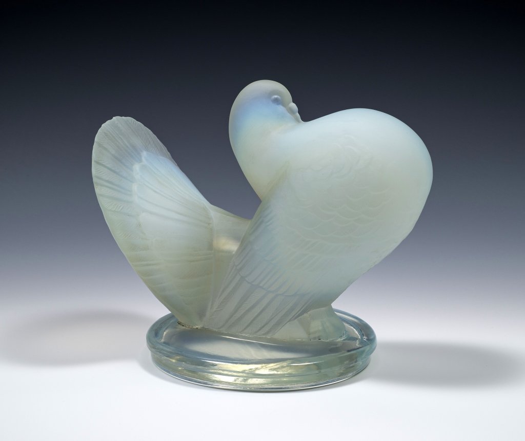 Opaline French Glass Dove with Chest Out: Item/Description: Opalescent art glass crystal bird, marked France. Clear base. Material: Glass. Dimensions: Height: 6"; Width: 6 1/2". Condition: Minor surface wear. Small flea bite to wing. Age: 20t