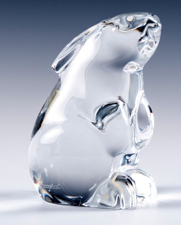 Baccarat Clear Sitting Bunny Rabbit: Item/Description: Signed crystal sitting rabbit figure. (France, Paperweight, Figurine, Hand Warmer) Material: Glass. Dimensions: Height: 3"; Width: 2". Condition: Minor surface wear. No noticeable ch