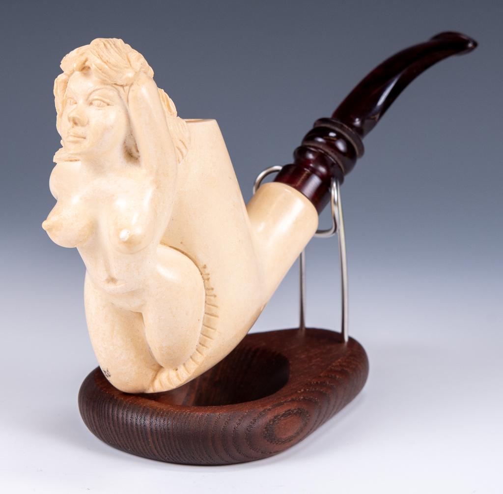 Carved Nude Meerschaum Estate Pipe: Item/Description: Meerschaum pipe features carved nude female figure. Display stand not included. (Smoking, Tobacco, Tobacciana) Shape: Freehand Bowl Material: Meerschaum; Stem Material: Acrylic Count