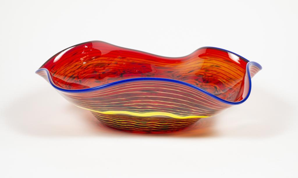 Signed Red Swirl Art Glass Bowl: Item/Description: Crimped, contemporary art glass centerpiece bowl in jewel tone red with concentric swirl pattern in yellow on reverse; rim edged in blue. Etched on base with artist's initials in scr