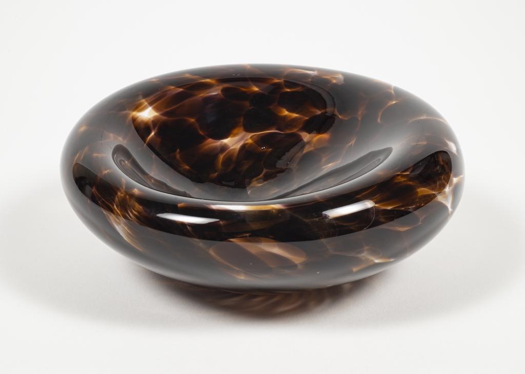 Modernist Mottled Brown Art Glass Bowl: Item/Description: Dimpled art glass decorative bowl. Mottled glass with swirl, feathered design. Organic design, soft lines. Open bottom. Unsigned. Material: Glass. Dimensions: 5 1/2"L x 2"W base diam