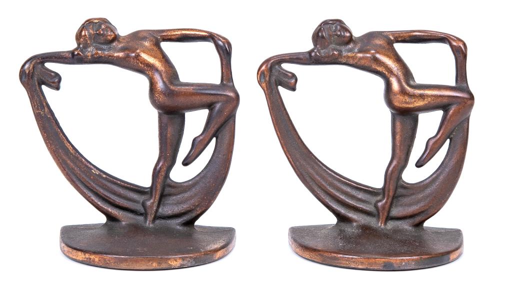 Art Deco Nude Dancers Cast Iron Book Ends: Item/Description: Pair of matching Art Deco era cast iron bookends fashioned as graceful nude dancers holding sashes. Cast iron with remnants of copper coating. Incised number on inner edge of each: 5