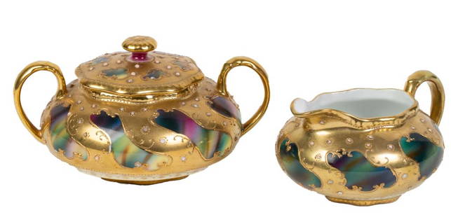 Maple Leaf Nippon Sugar & Creamer Set: Item/Description: Two piece set includes lidded, handled sugar bowl and creamer. Hand painted gold design over iridescent multi-colored porcelain. Material: Porcelain Sugar bowl dimensions: Length: 6