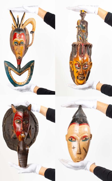West African Style Mask Grouping: Item/Description: Four assorted decorative African masks. Lot includes: - Colorful West African style painted masks. Two-tiered hand carved decorative mask. Material: Wood, paint, straw, twine Dimensi